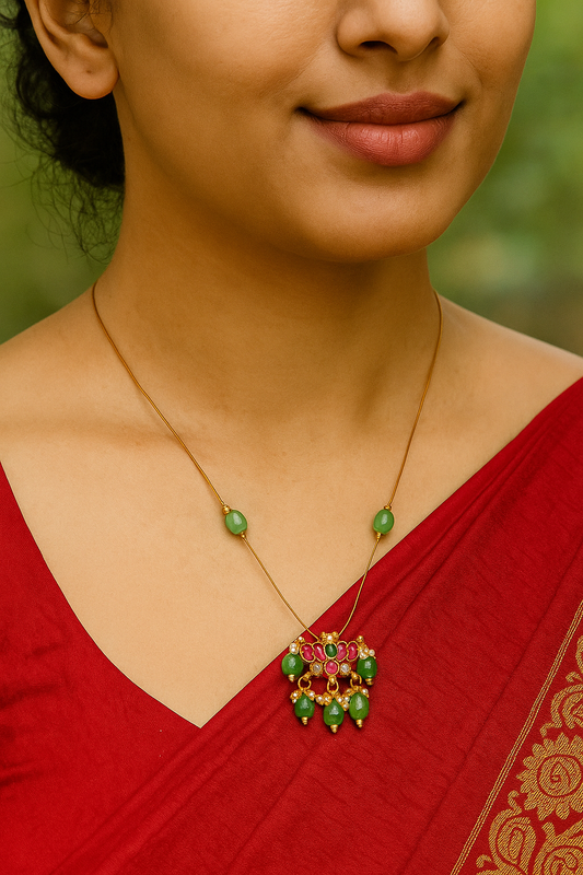 Elegant Gold Necklace with Green Beads and Red Gem Accents